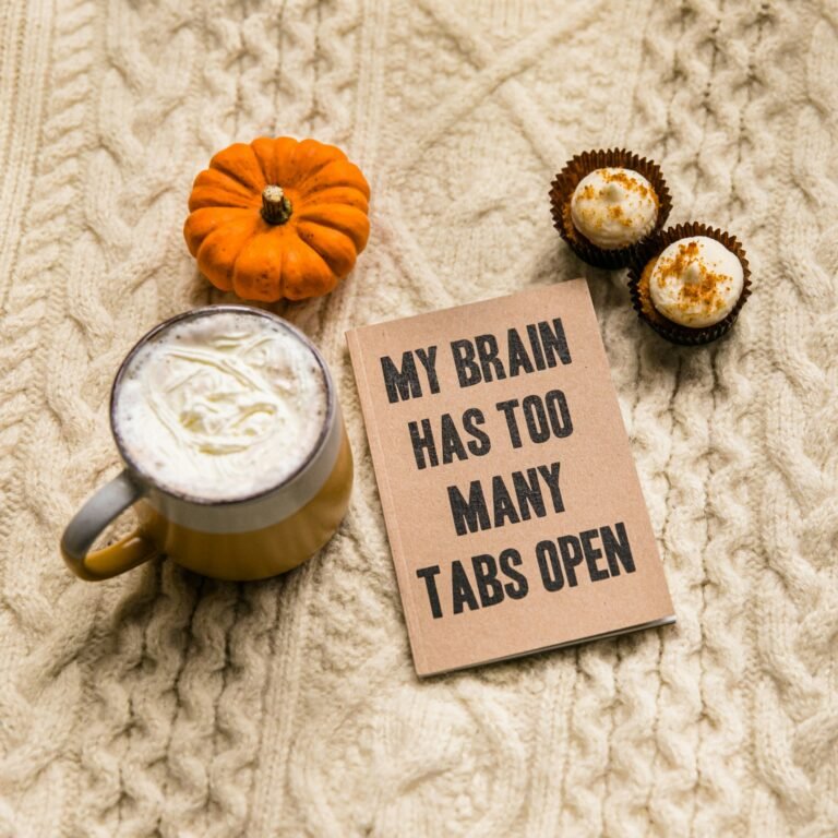 Notebook reading My Brain Has Too Many Tabs Open beside a latte and a mini pumpkin