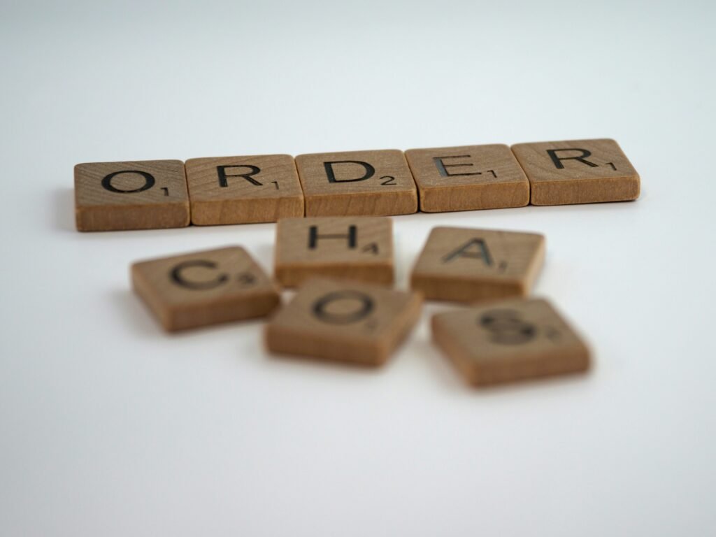crabble tiles spelling ORDER above scattered tiles spelling CHAOS
