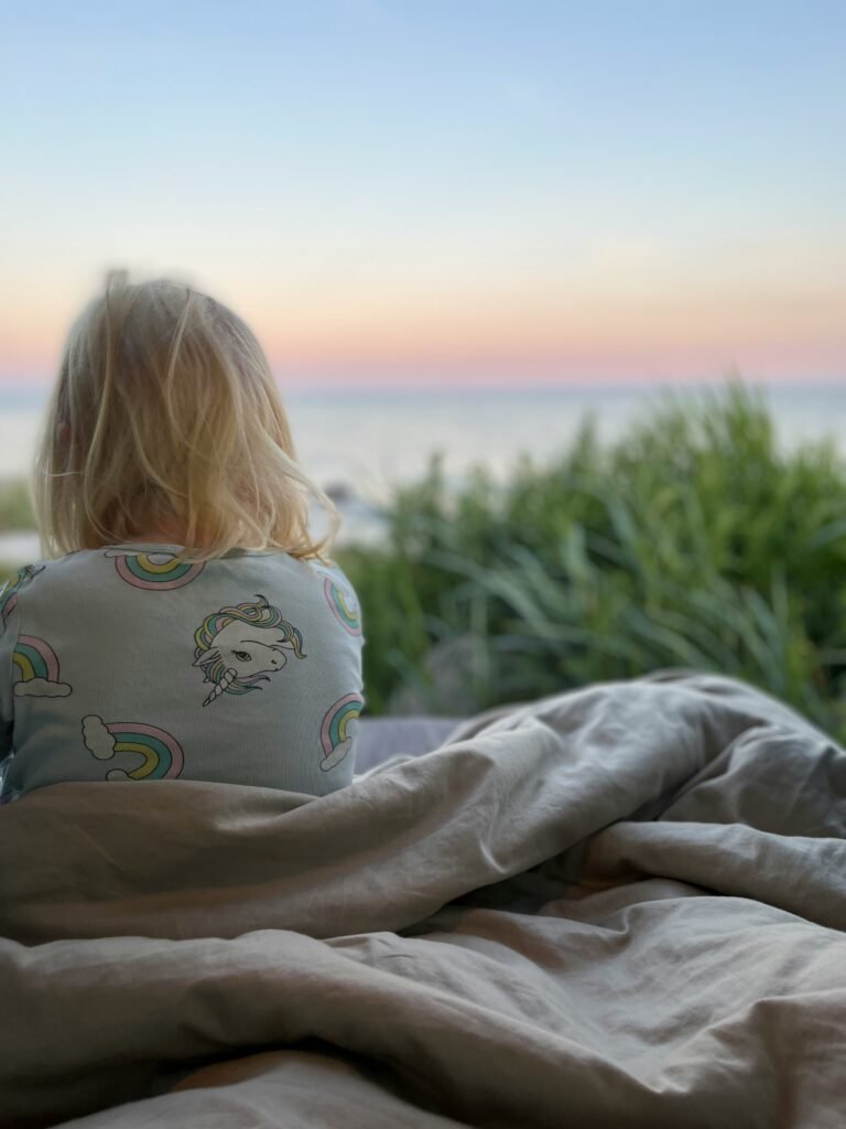 Child in pyjamas waking at sunrise