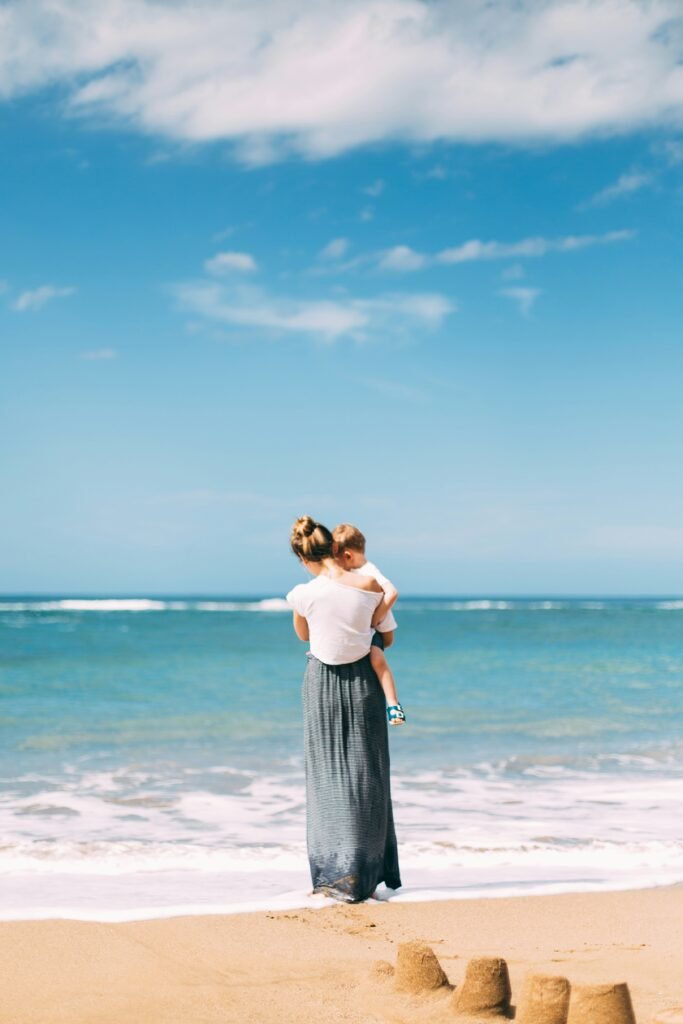 Mother holding her child at the beach