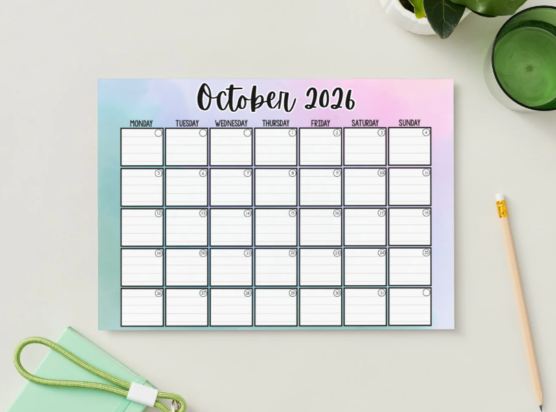 Printable October 2026 watercolor calendar, Monday start, styled on a desk with a plant and pencil